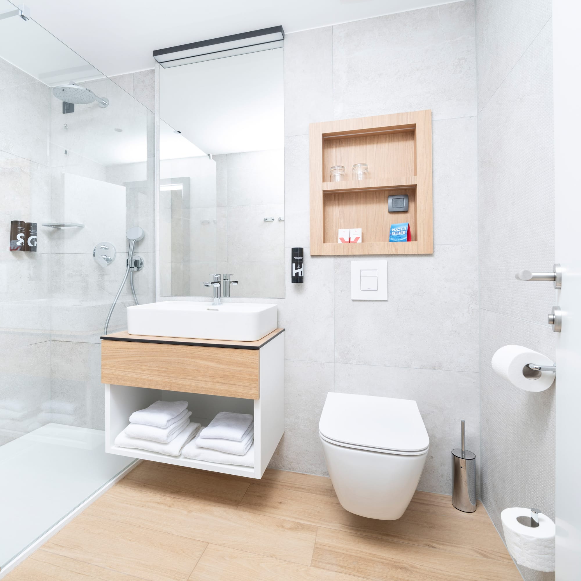 a bathroom with a glass shower and a sink