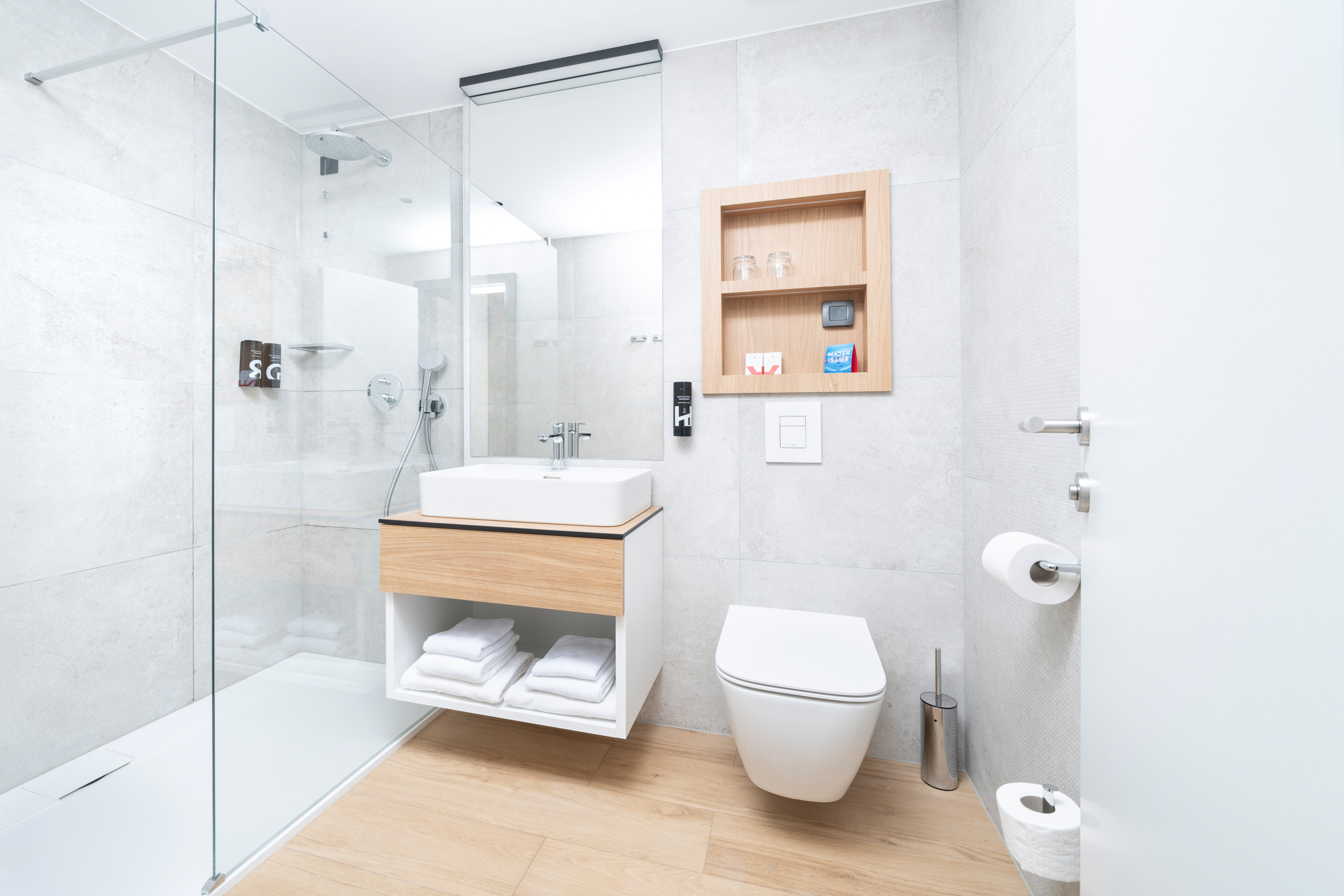 a bathroom with a glass shower and a sink