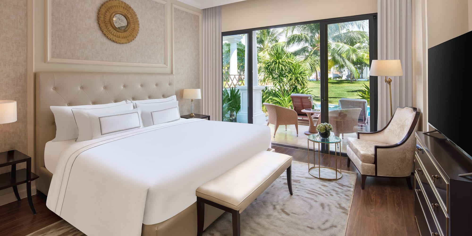 a bedroom with a bed and chairs