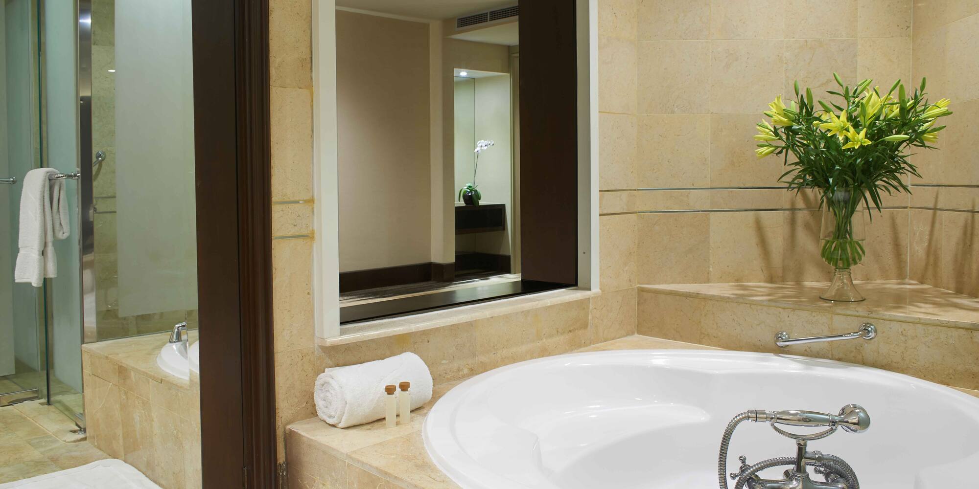 a bathroom with a large tub and a mirror