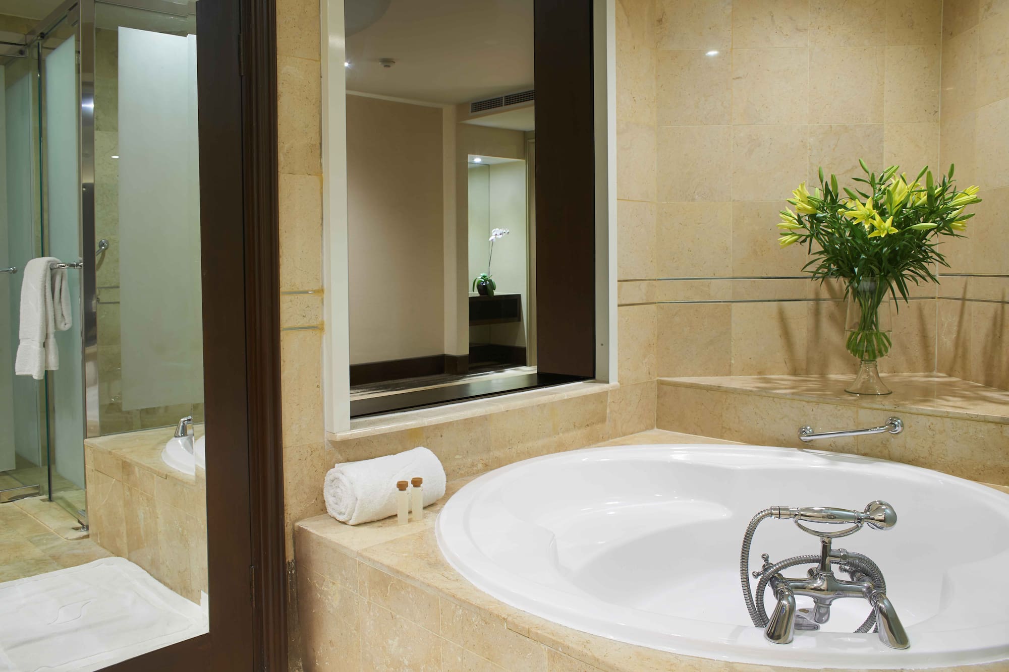 a bathroom with a large tub and a mirror