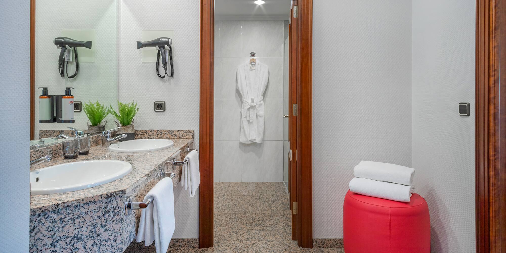 a bathroom with marble countertops and white towels