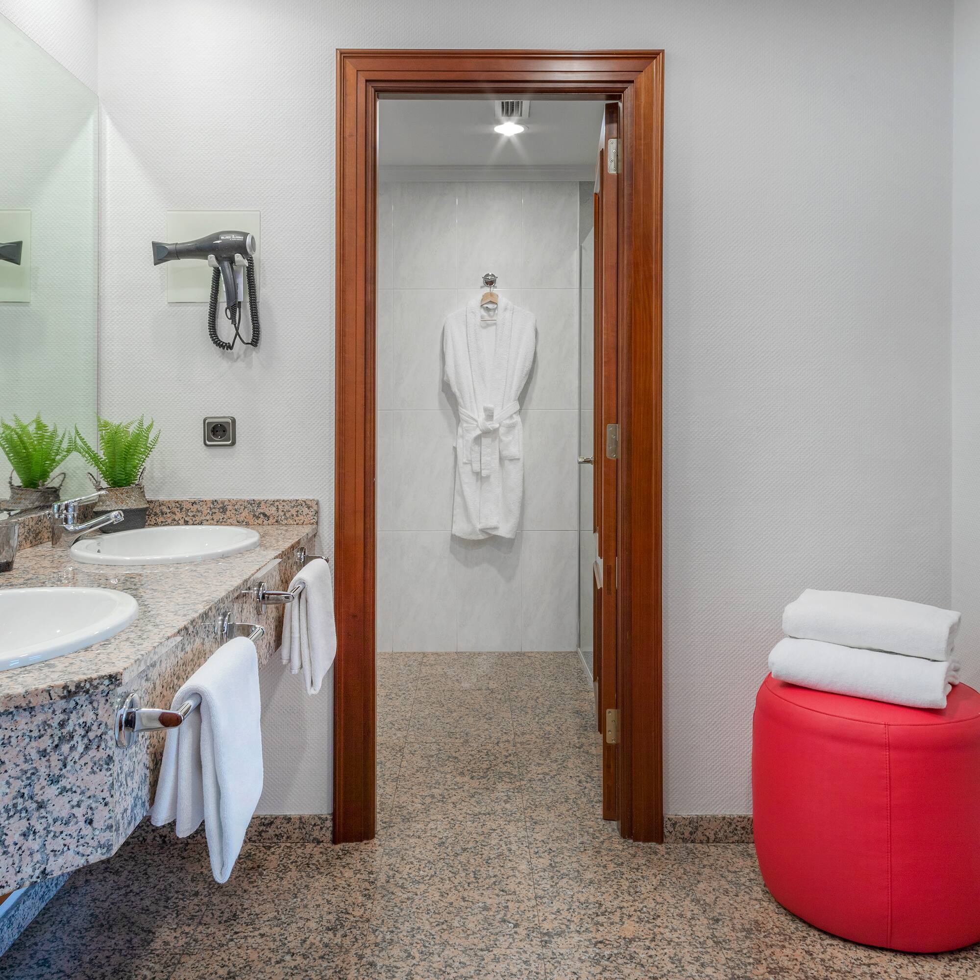 a bathroom with marble countertops and white towels