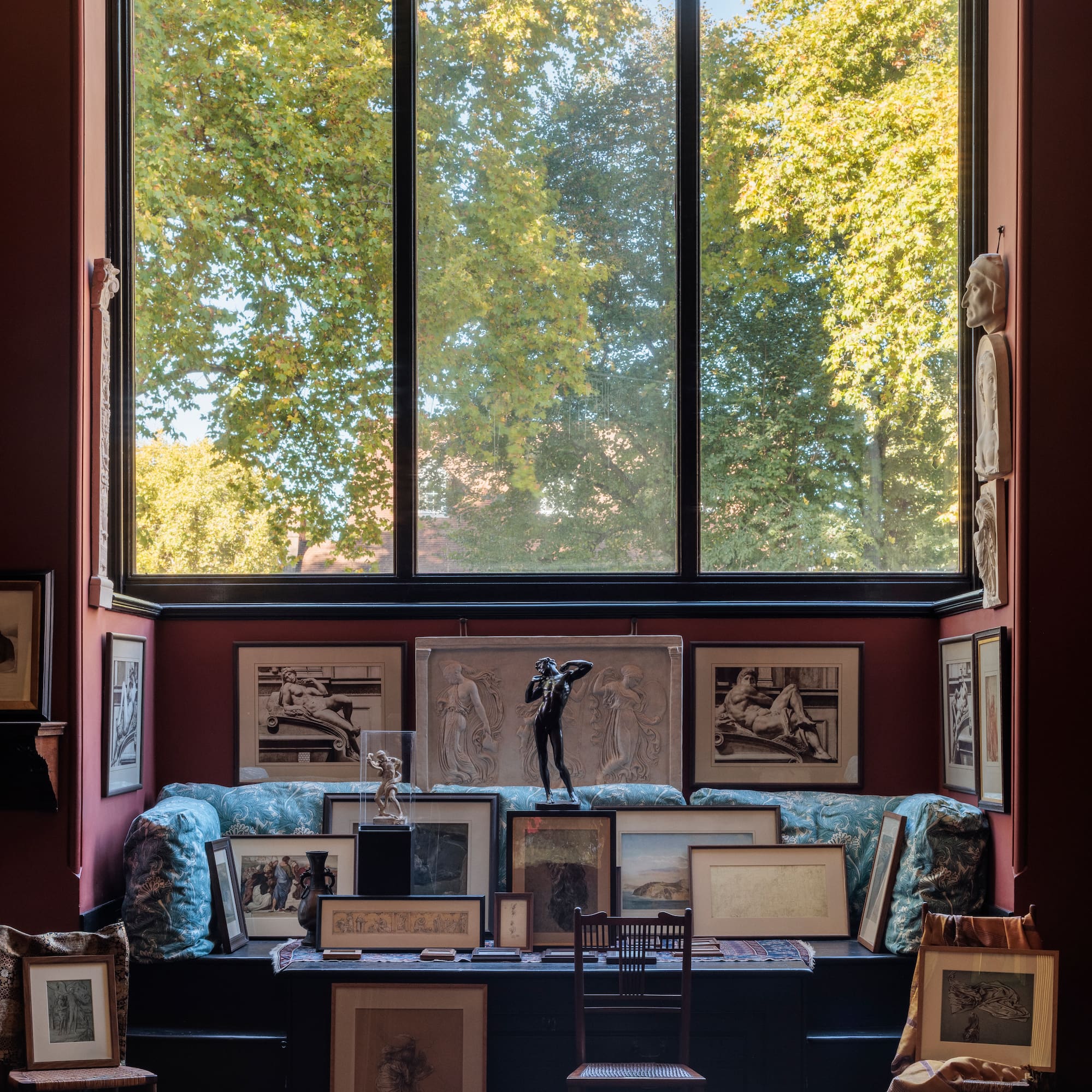 a room with a large window and a group of pictures