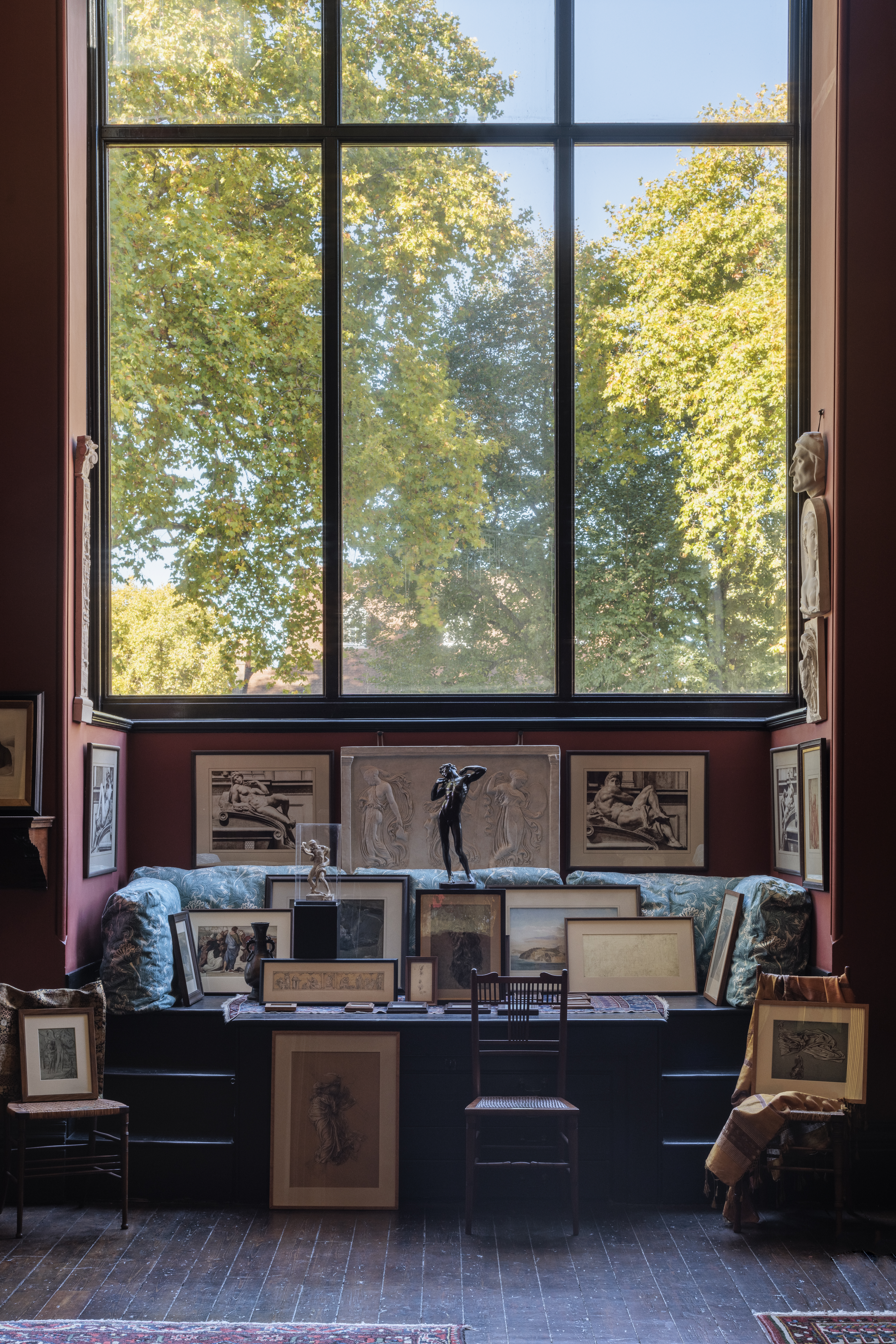 a room with a large window and a group of pictures