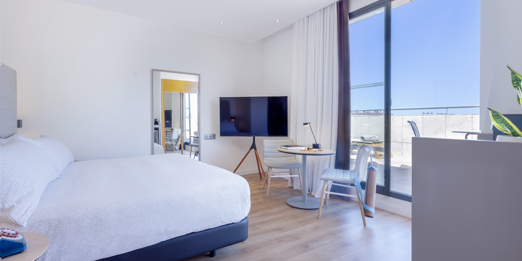 a bedroom with a large window and a bed