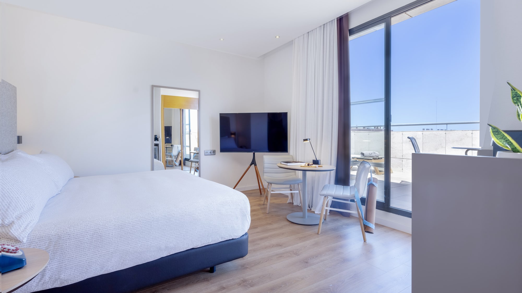 a bedroom with a large window and a bed