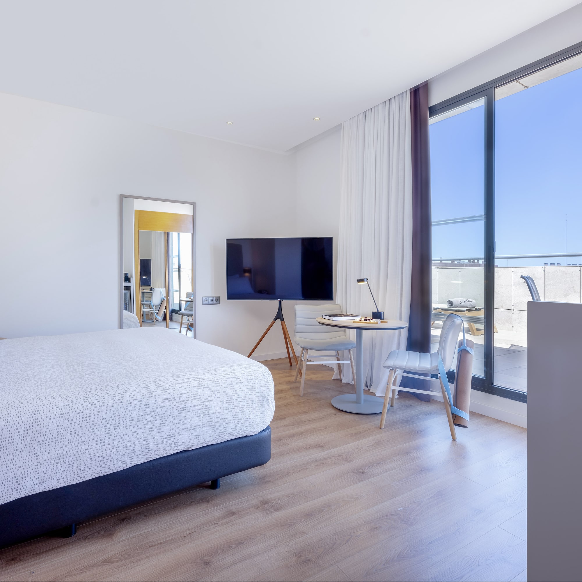 a bedroom with a large window and a bed