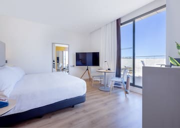 a bedroom with a large window and a bed