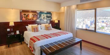 a bedroom with a bed and a table