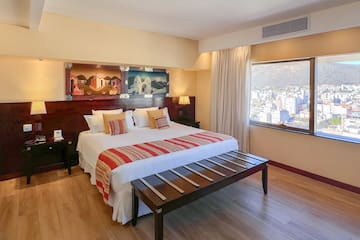 a bedroom with a bed and a table