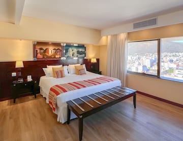 a bedroom with a bed and a table