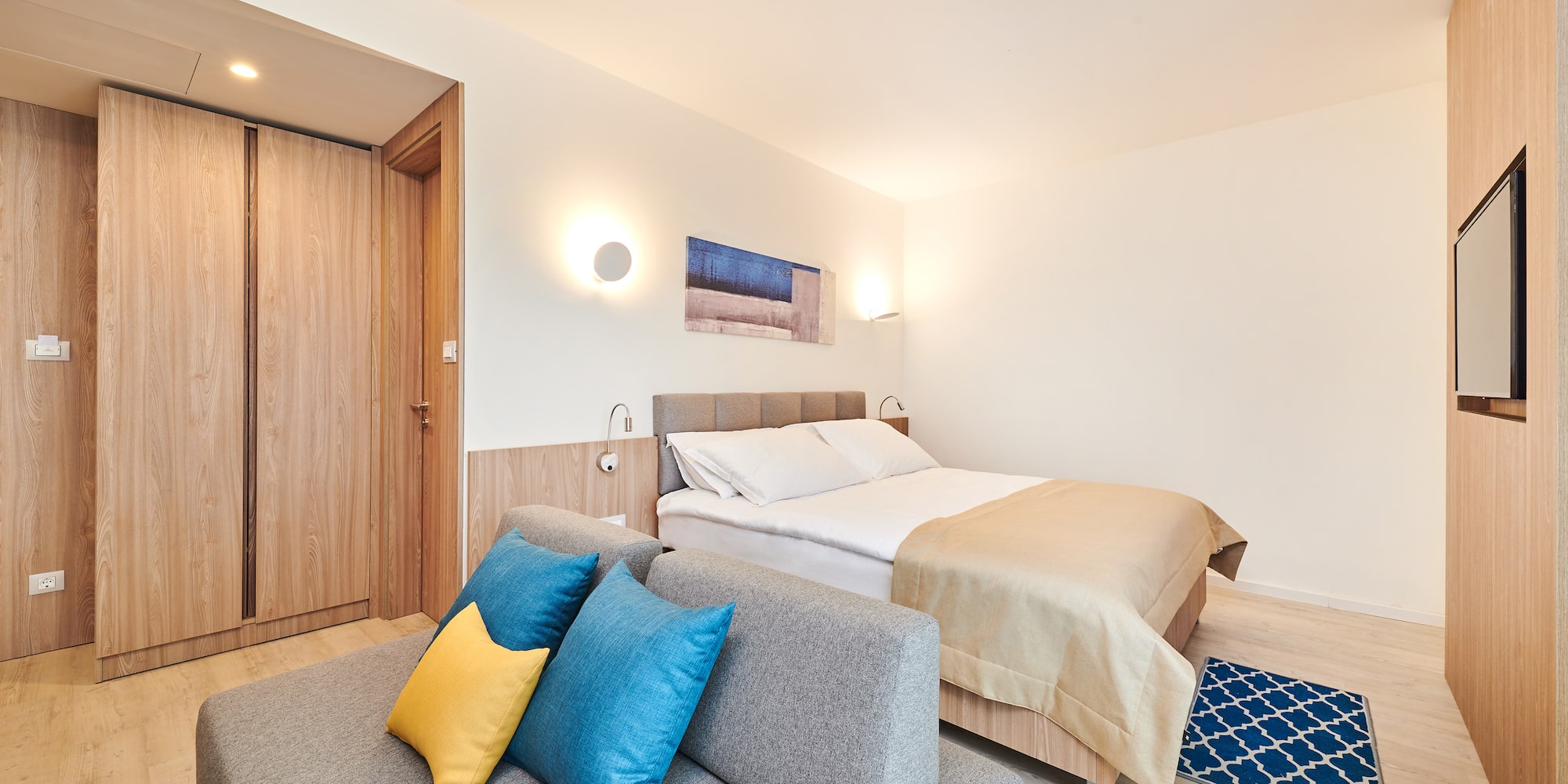 a bedroom with a bed and a couch