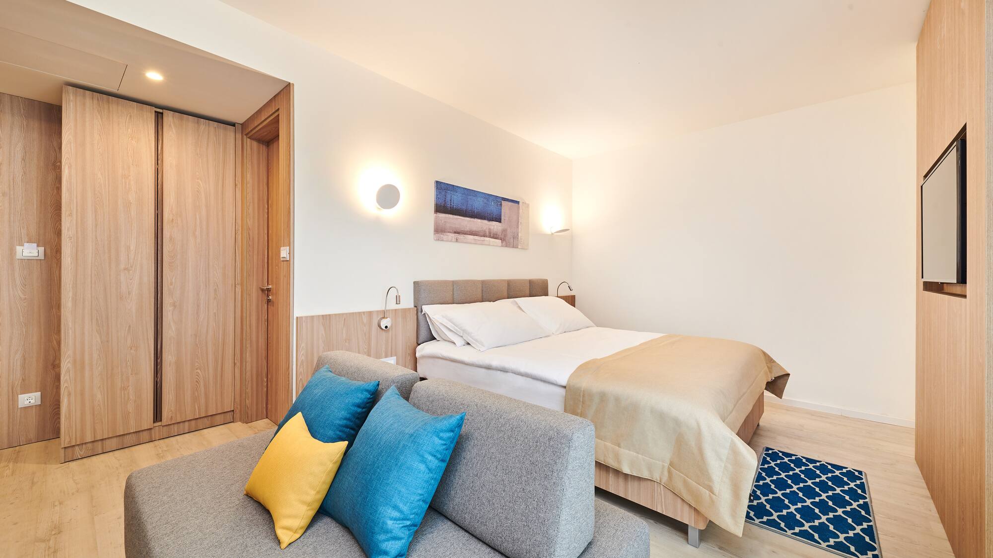 a bedroom with a bed and a couch