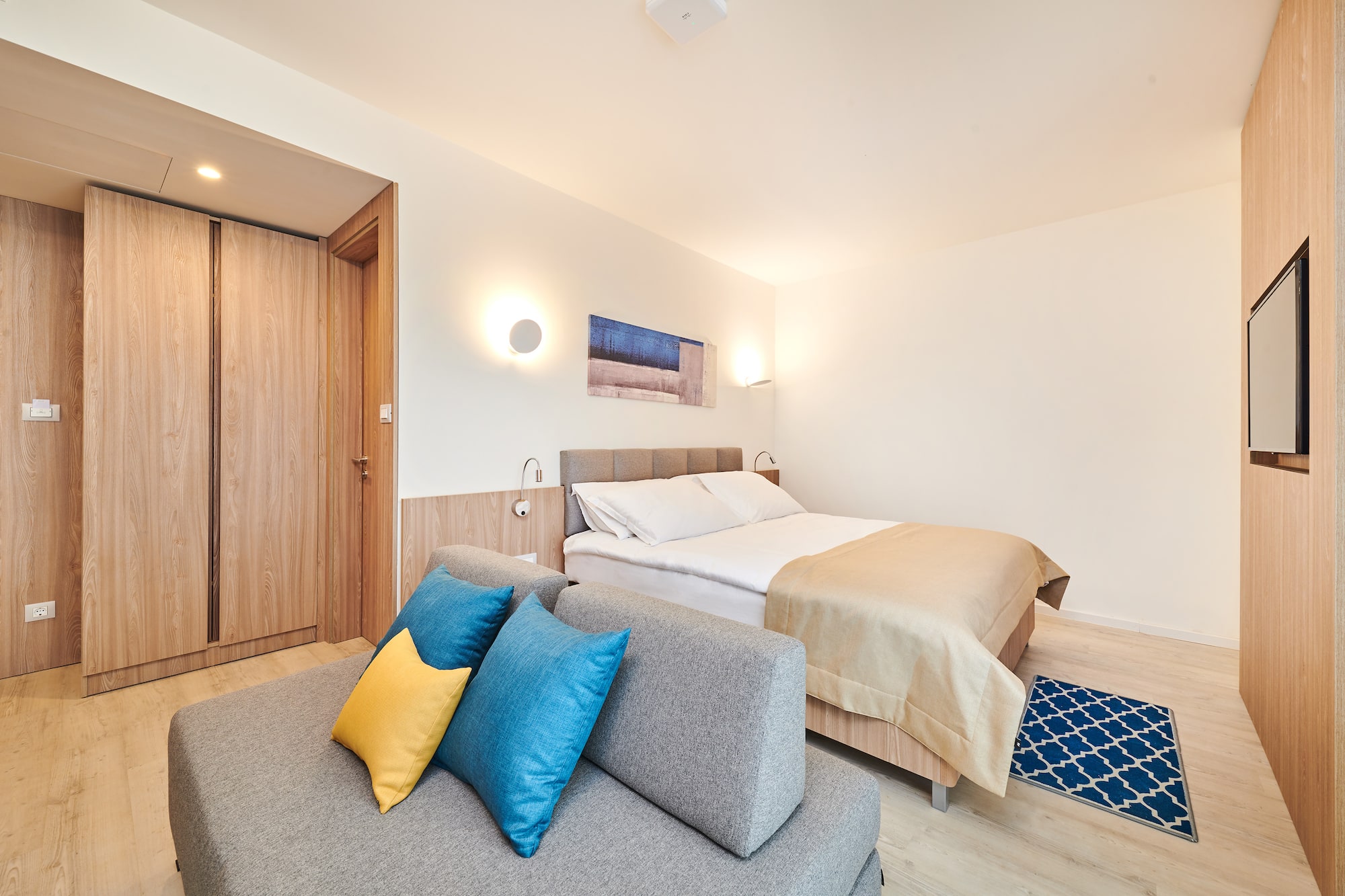 a bedroom with a bed and a couch