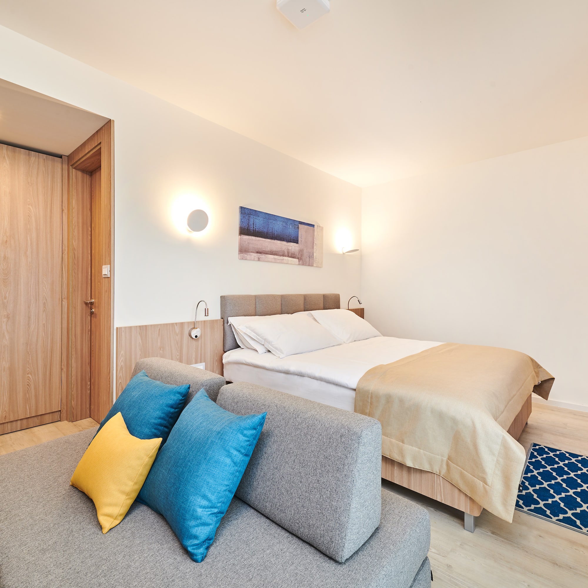 a bedroom with a bed and a couch