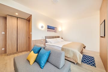 a bedroom with a bed and a couch