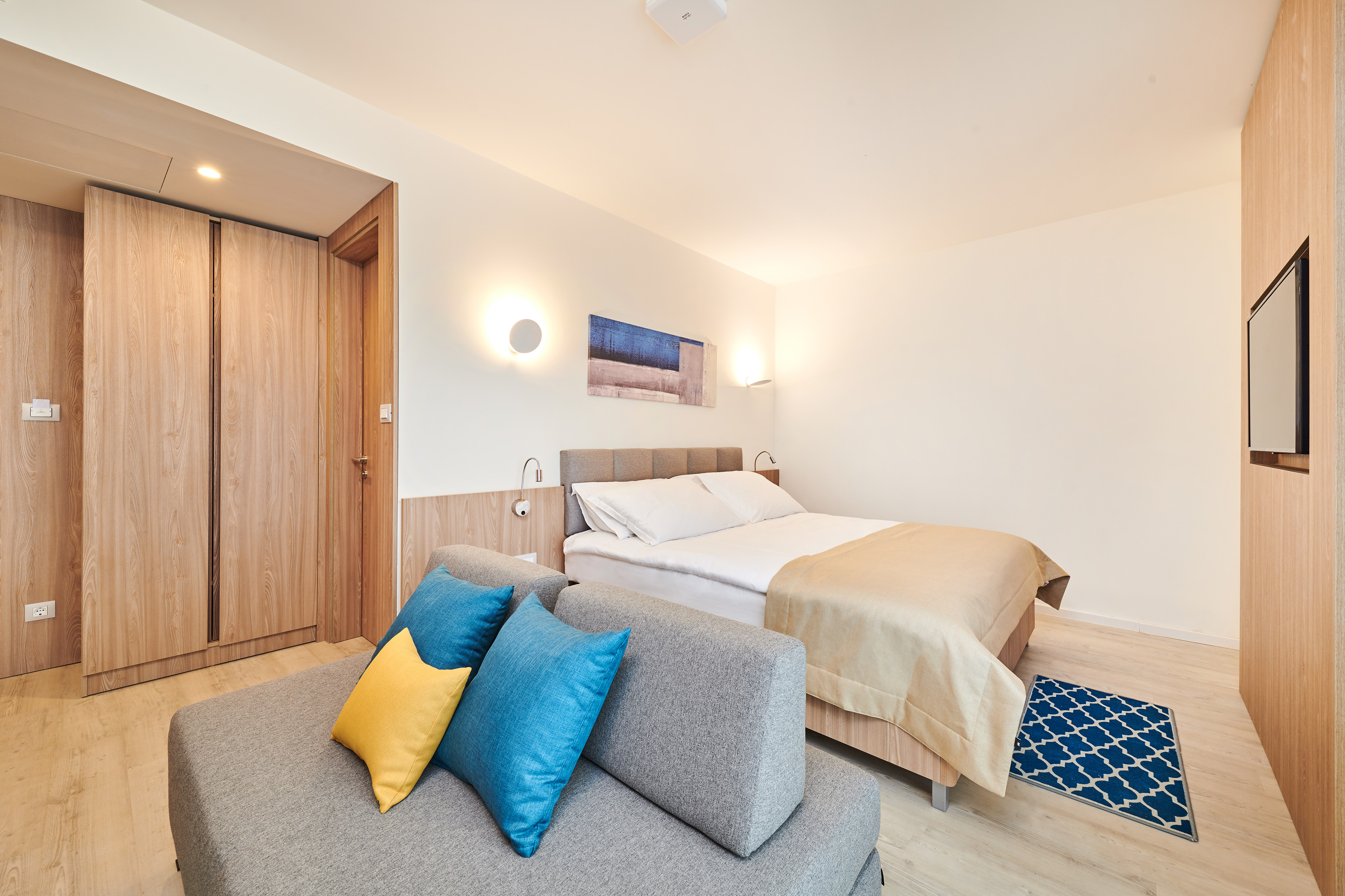 a bedroom with a bed and a couch