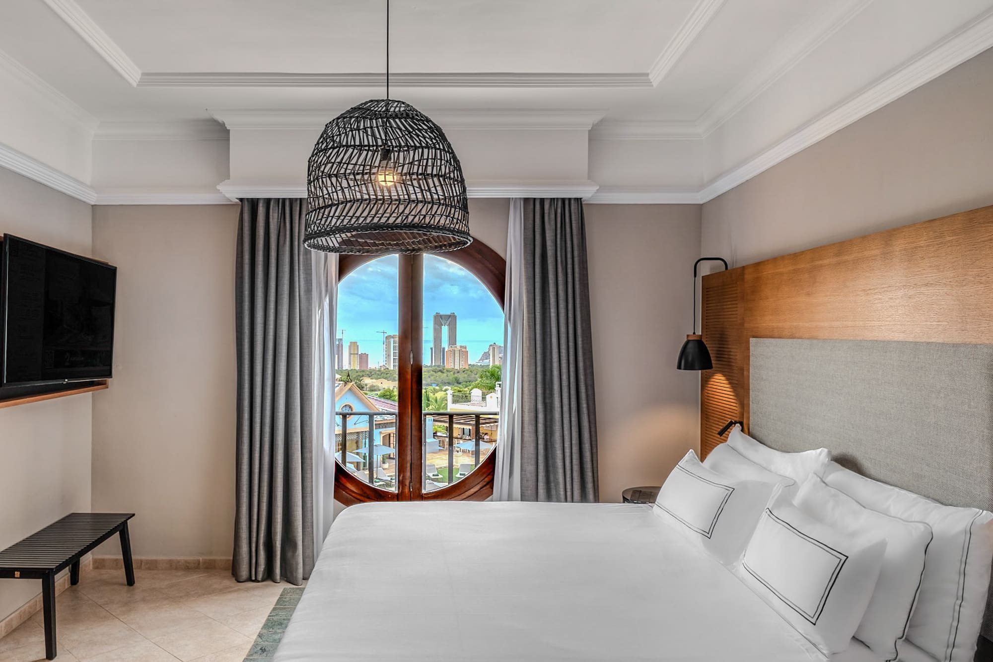 a bedroom with a large bed and a round window