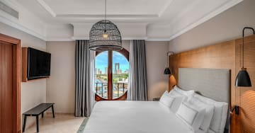 a bedroom with a large bed and a round window