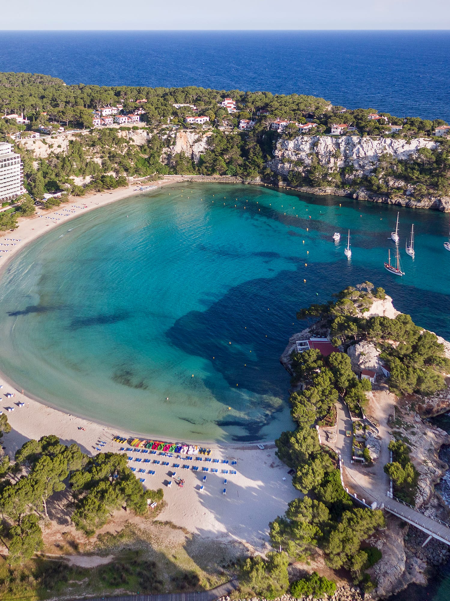 a beach with boats and a body of water