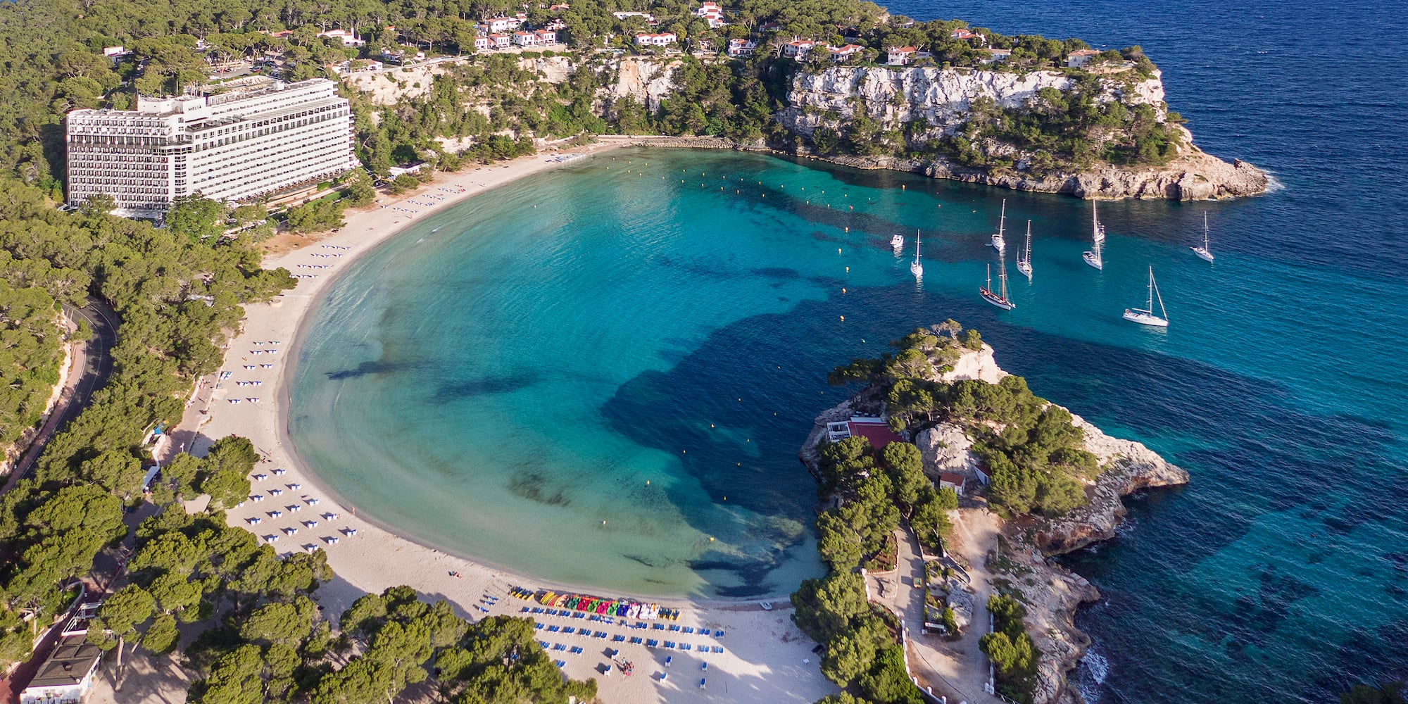 a beach with boats and a body of water