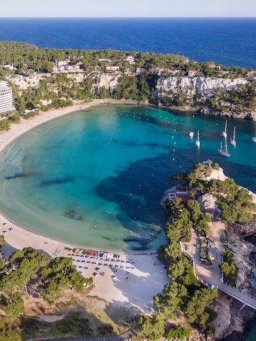 a beach with boats and a body of water