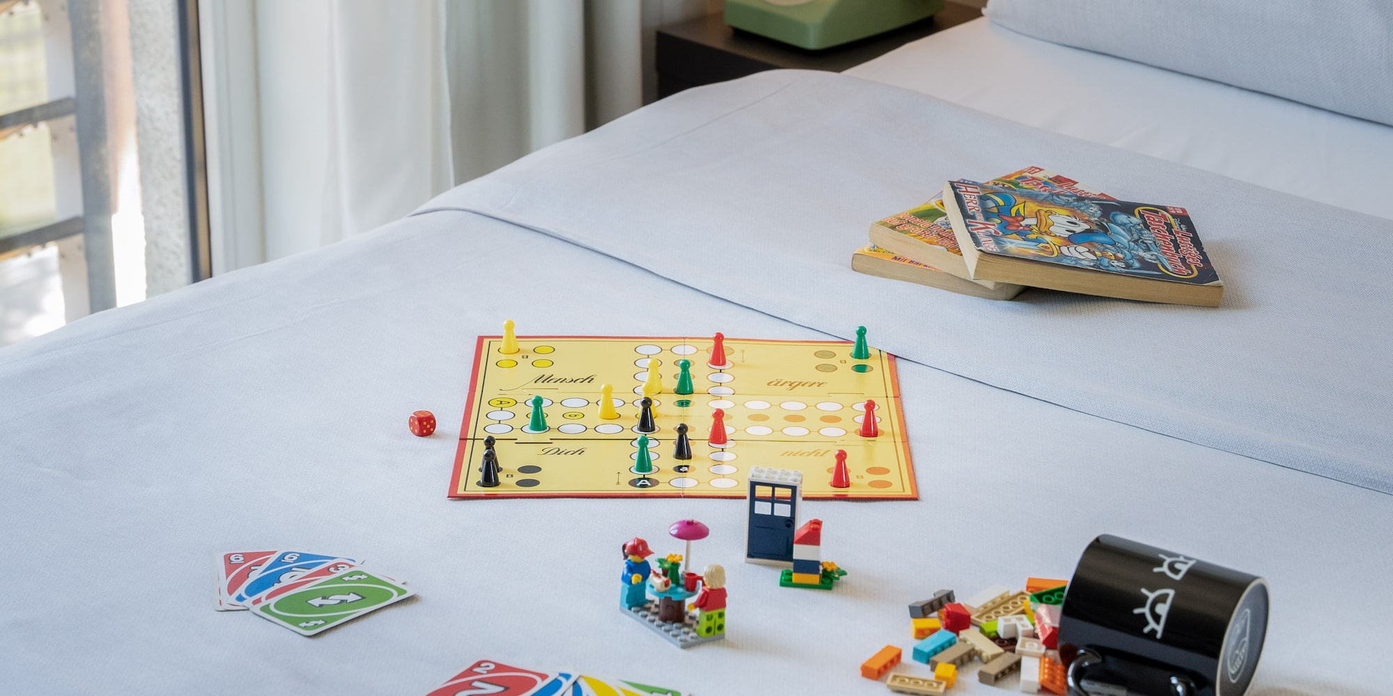 a board game and books on a bed