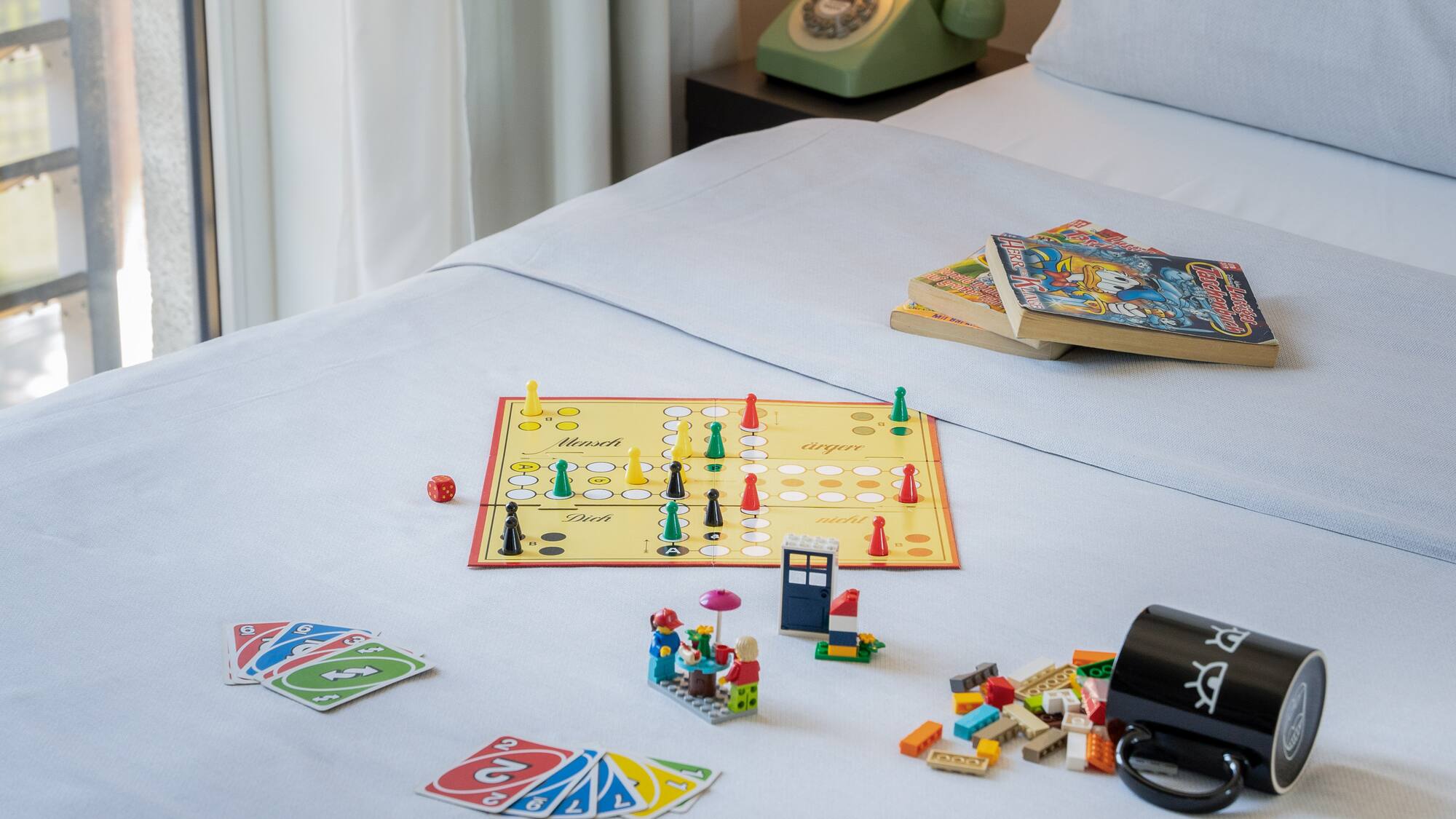 a board game and books on a bed