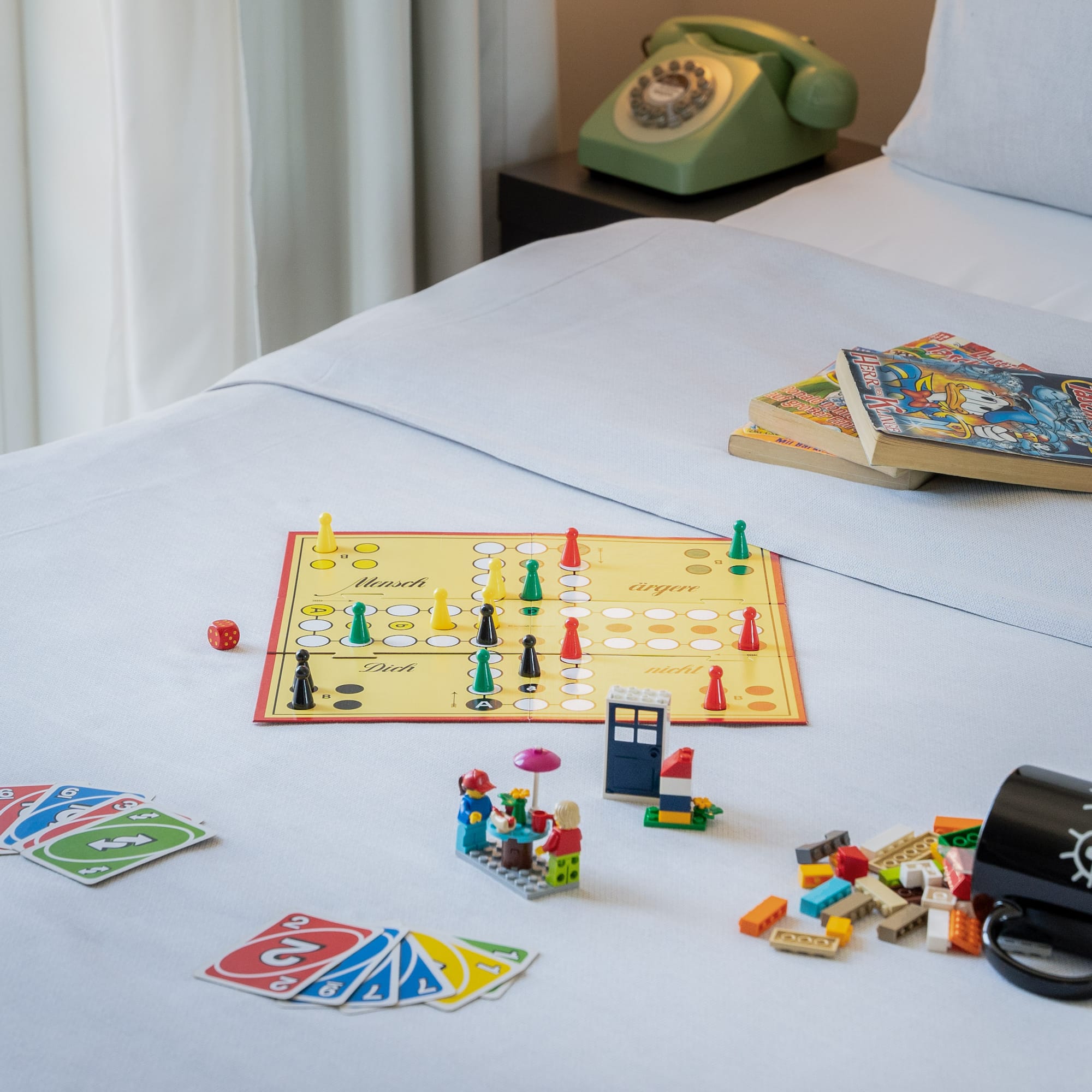 a board game and books on a bed