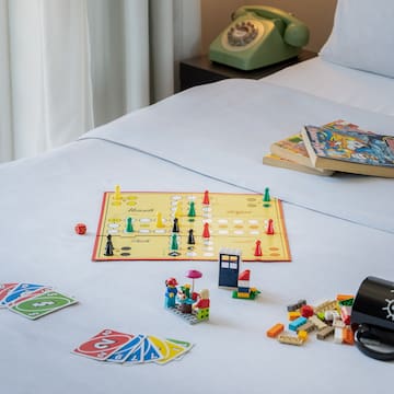 a board game and books on a bed