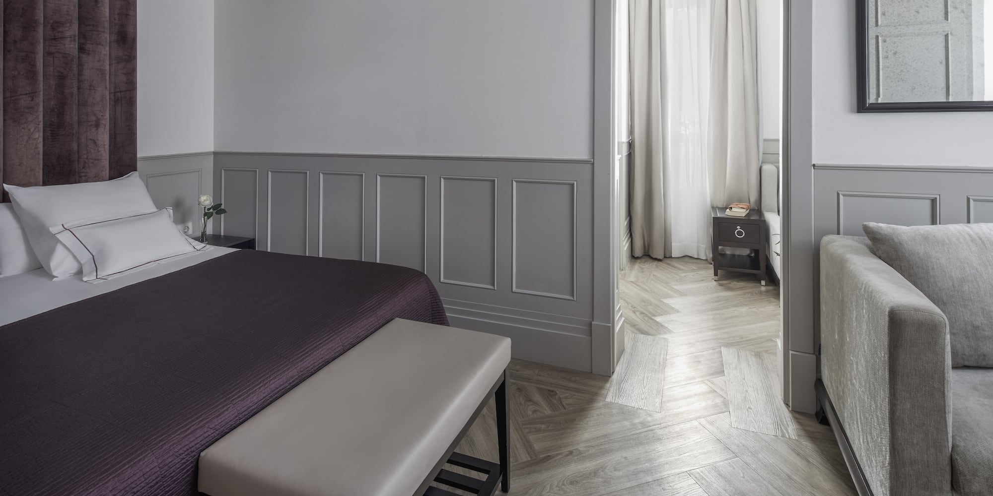 a bedroom with a bed and a bed bench