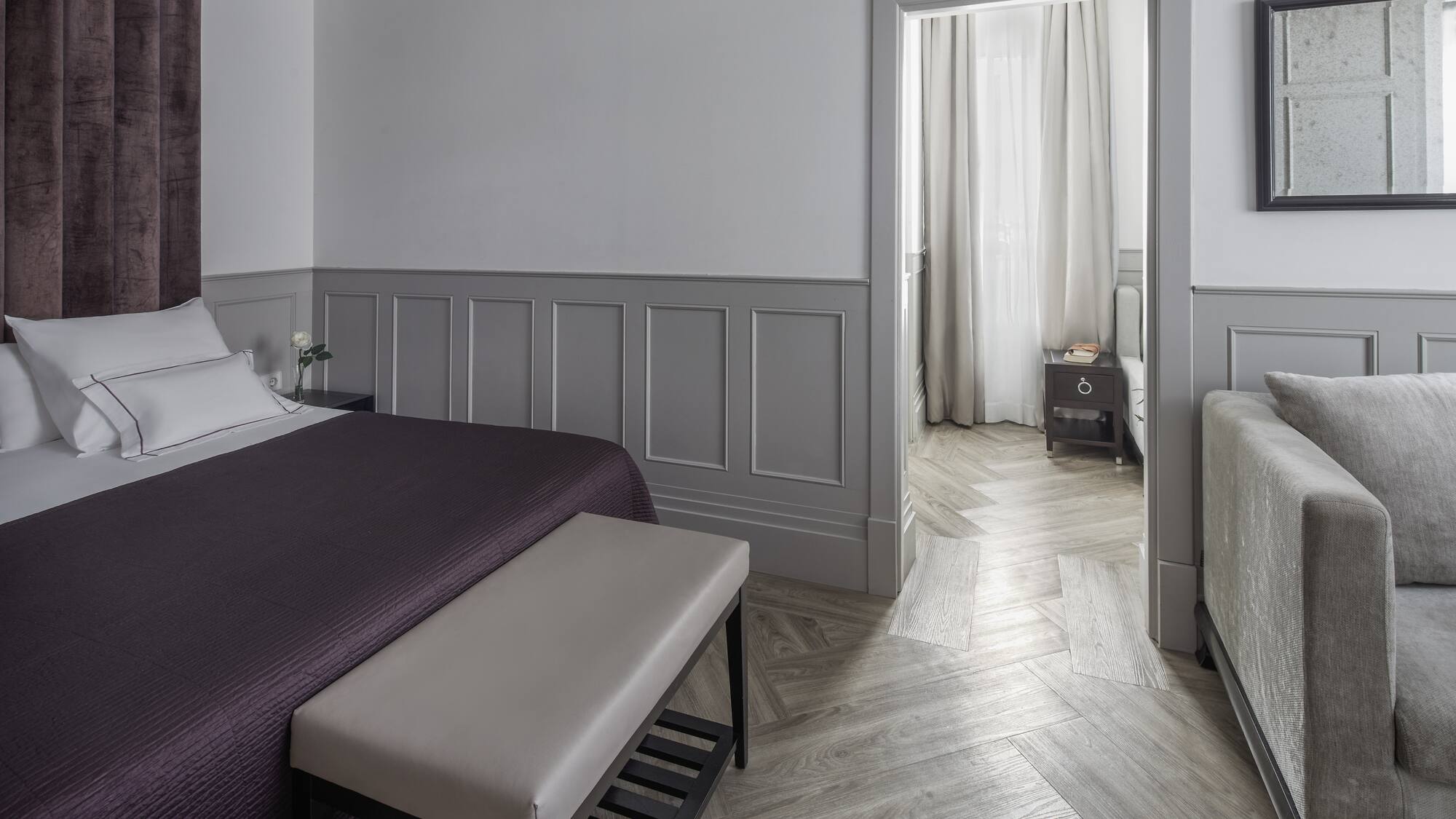 a bedroom with a bed and a bed bench