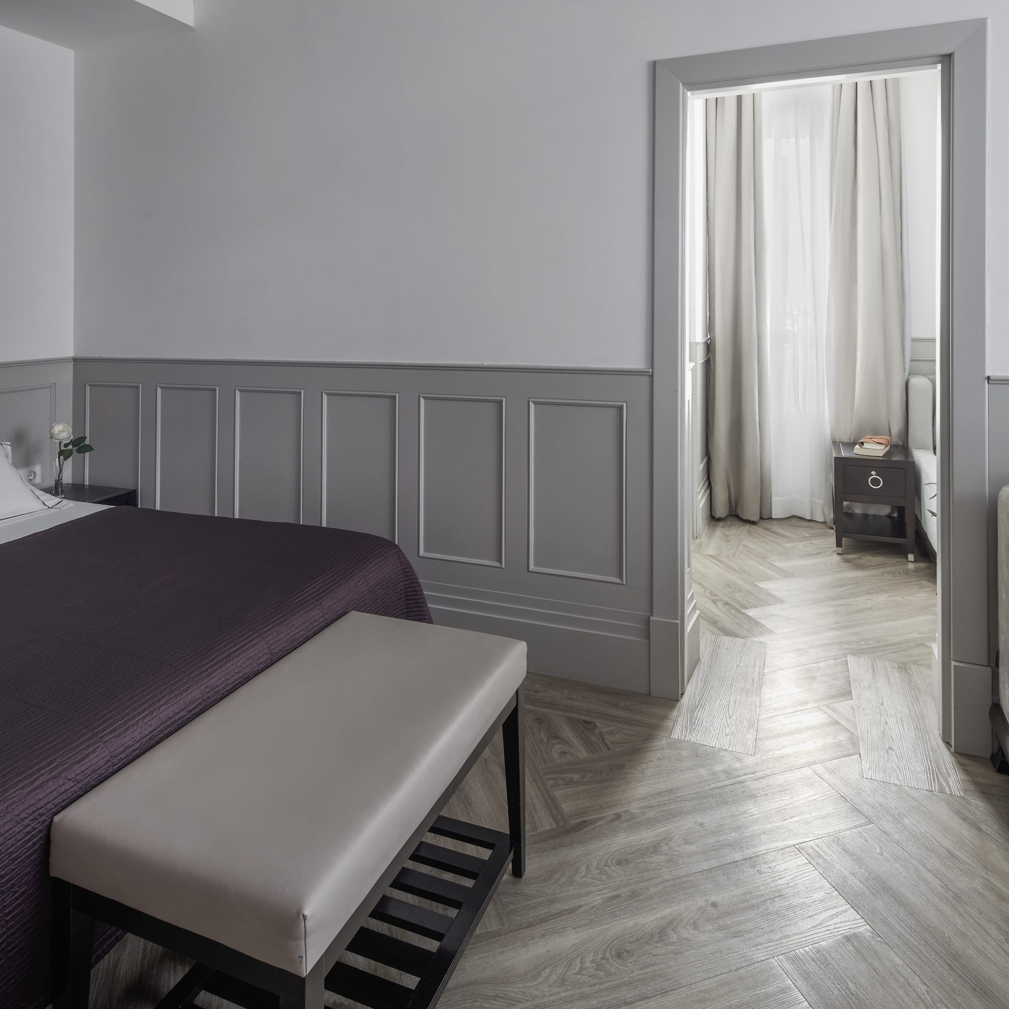 a bedroom with a bed and a bed bench