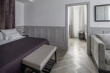 a bedroom with a bed and a bed bench