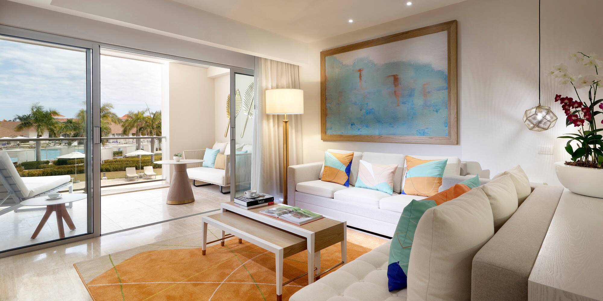 a living room with a large painting on the wall