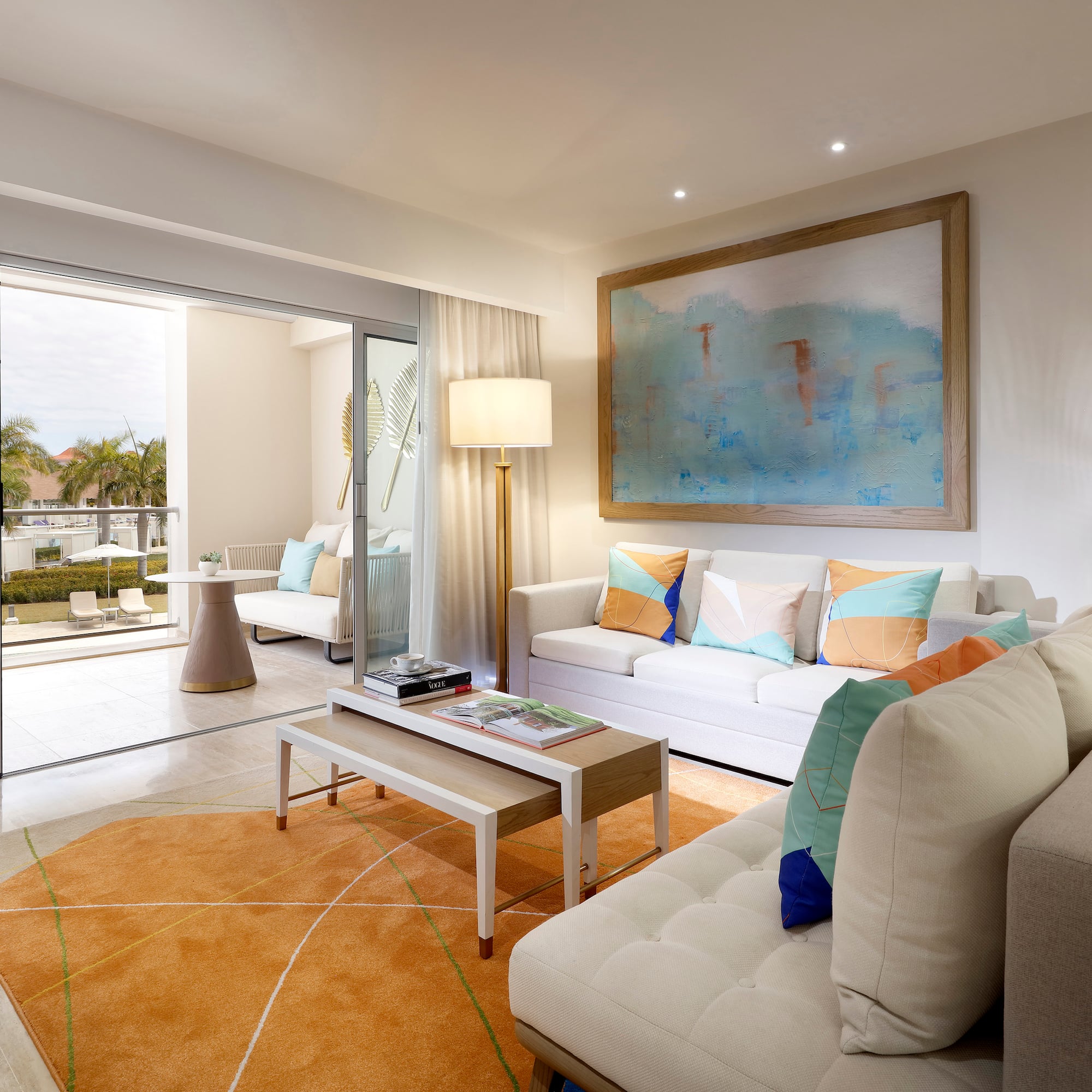 a living room with a large painting on the wall