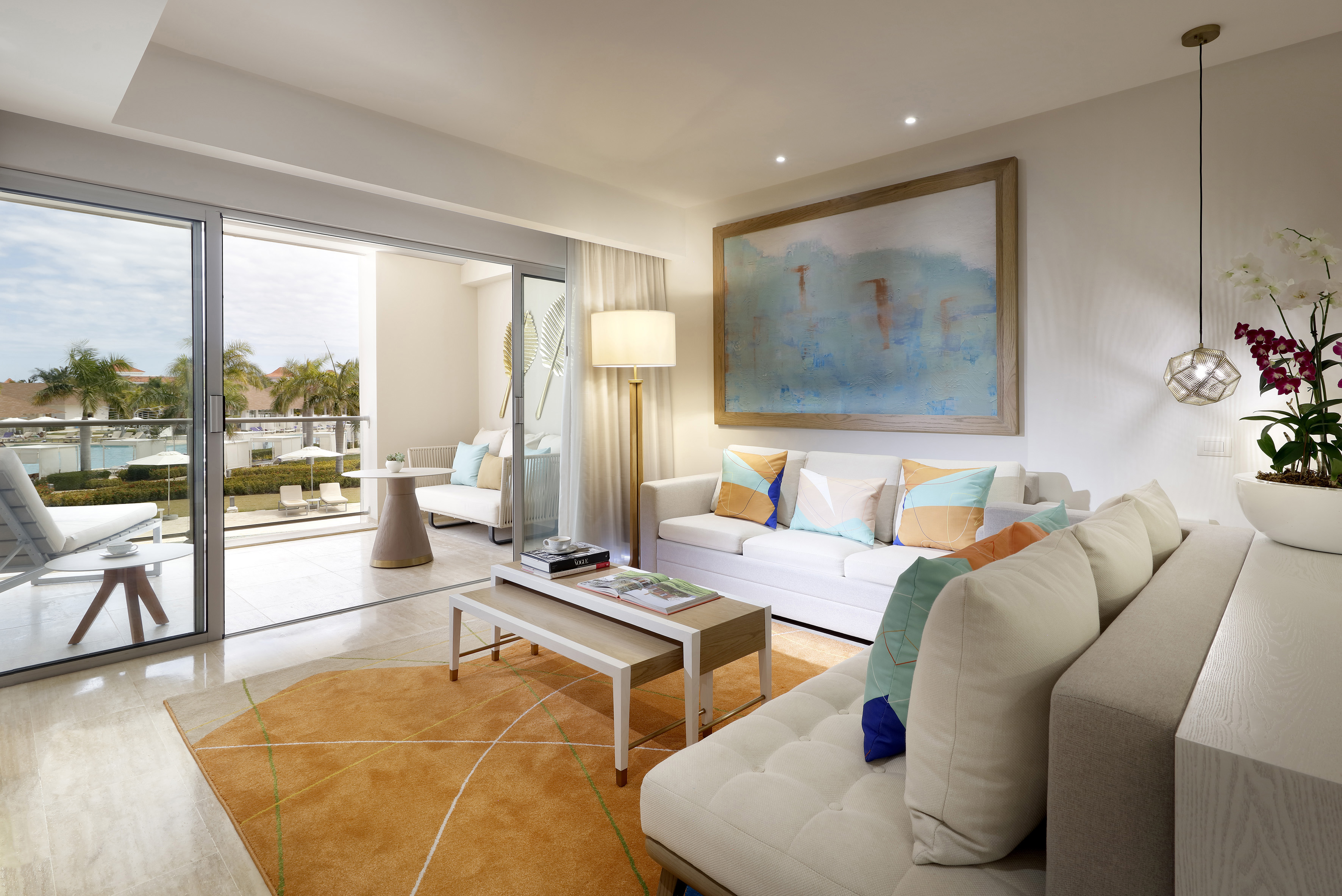 a living room with a large painting on the wall