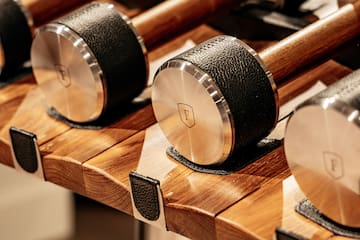 a row of dumbbells on a shelf