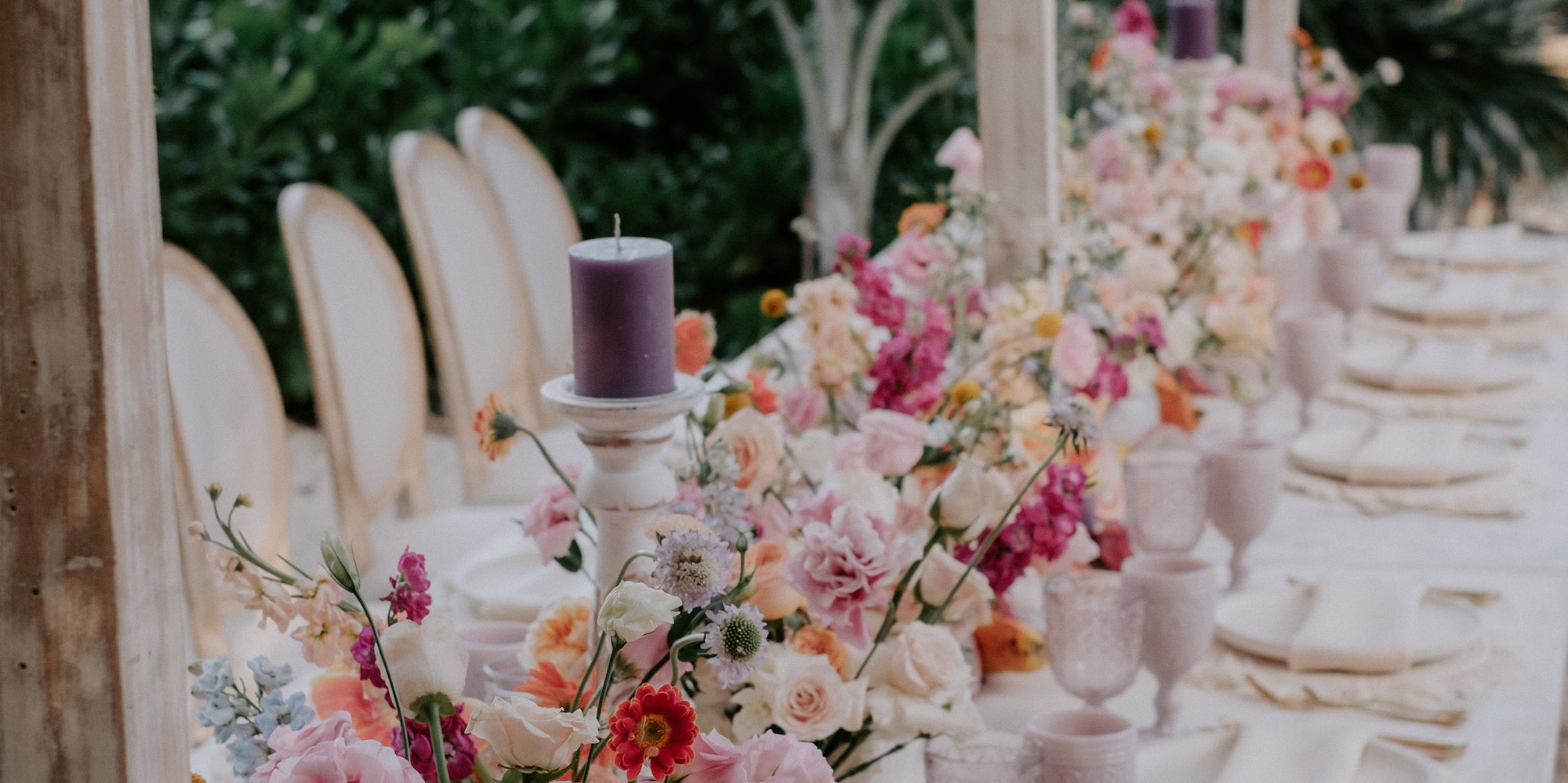 a table with flowers and candles
