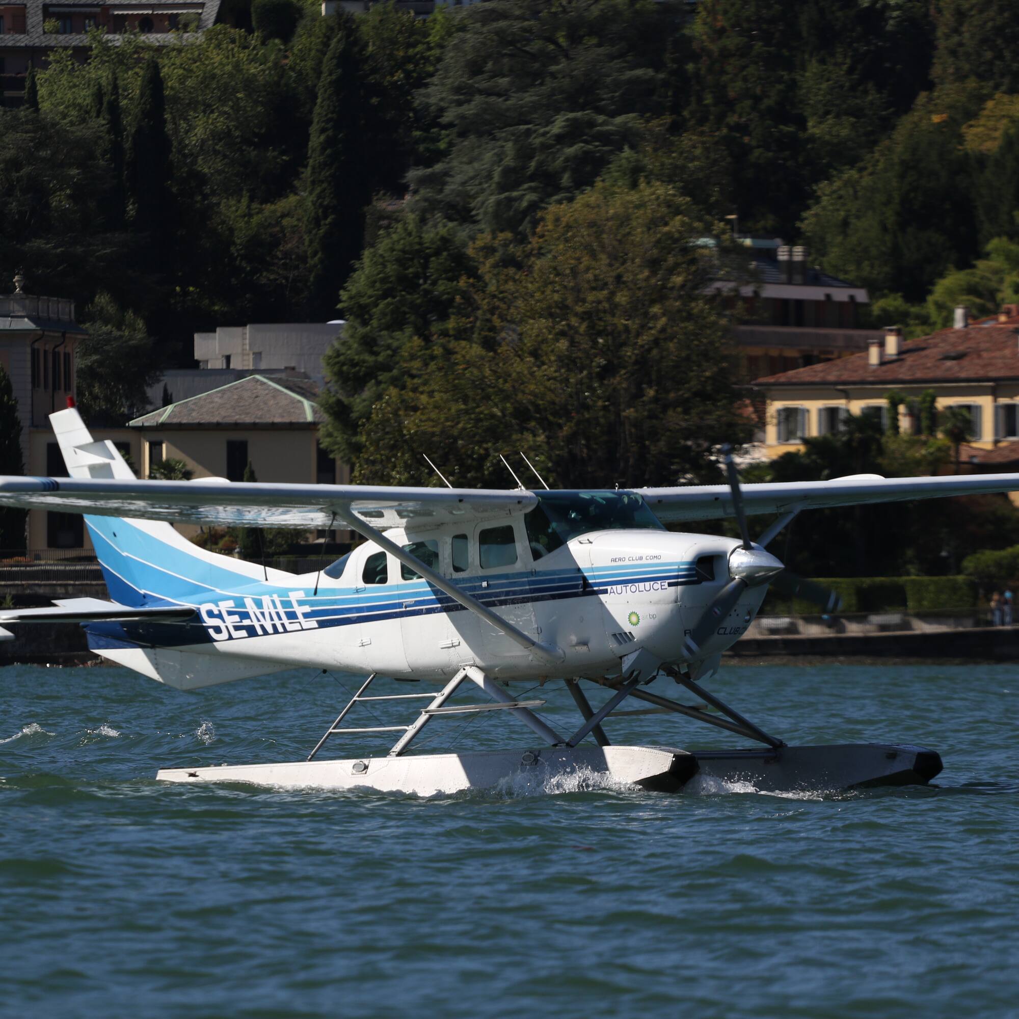 a seaplane on water near buildings
