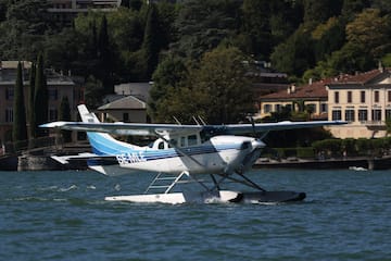 a seaplane on water near buildings