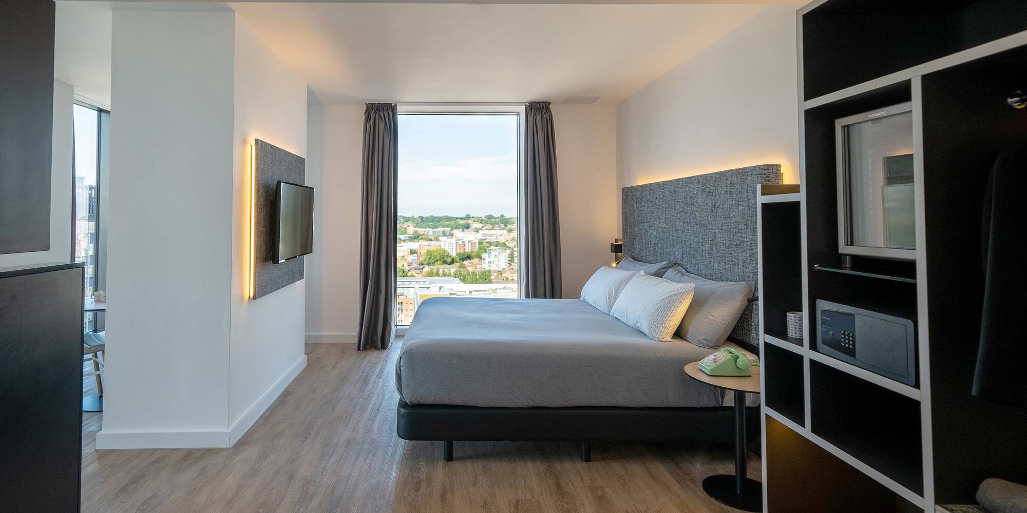 a bedroom with a tv and a bed