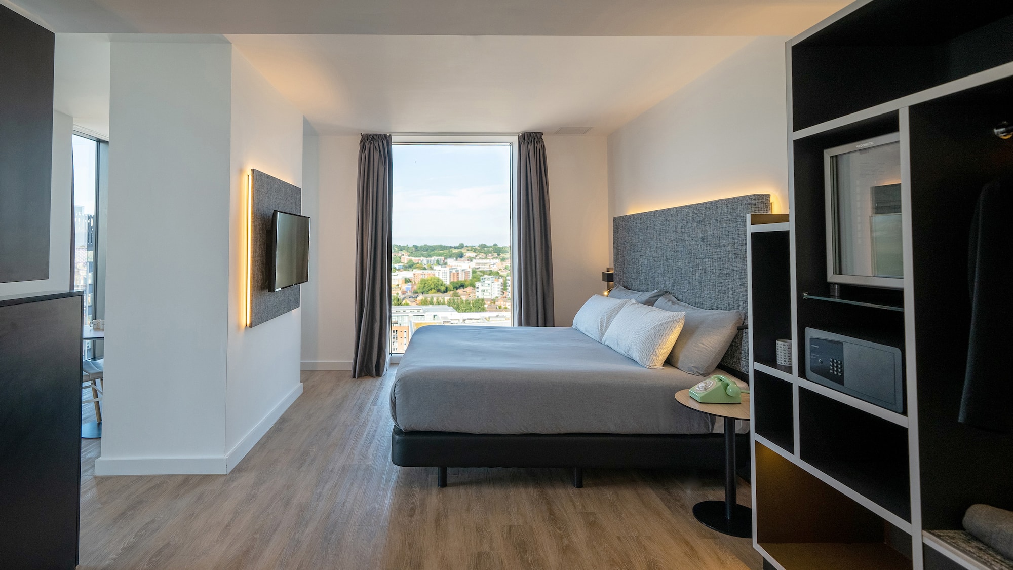 a bedroom with a tv and a bed