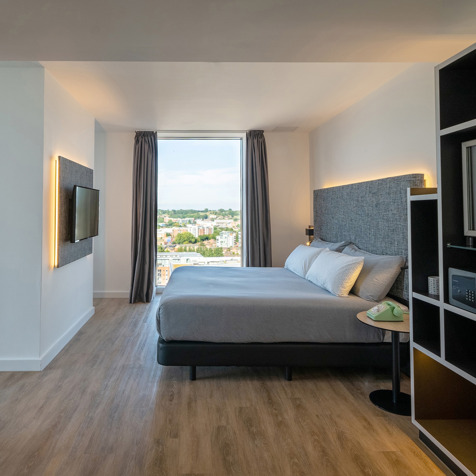 a bedroom with a tv and a bed