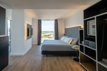 a bedroom with a tv and a bed