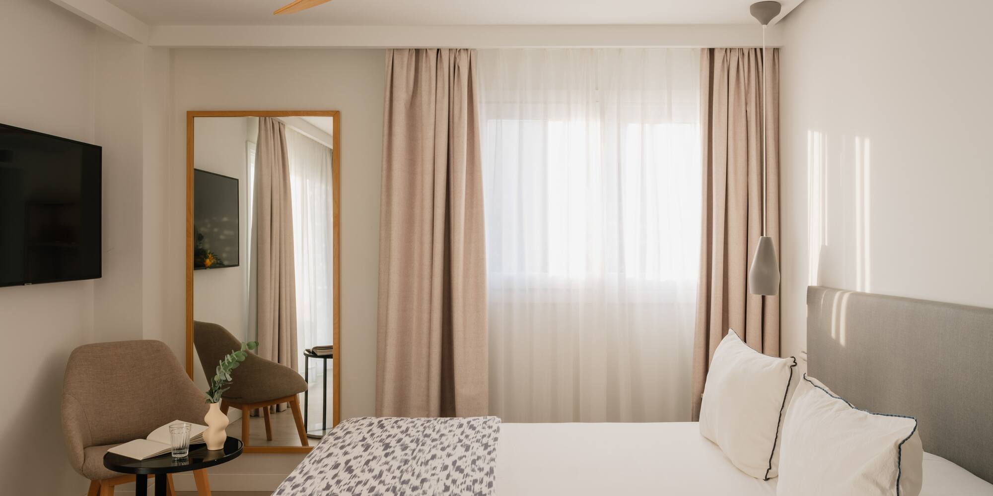 a room with a bed and a fan