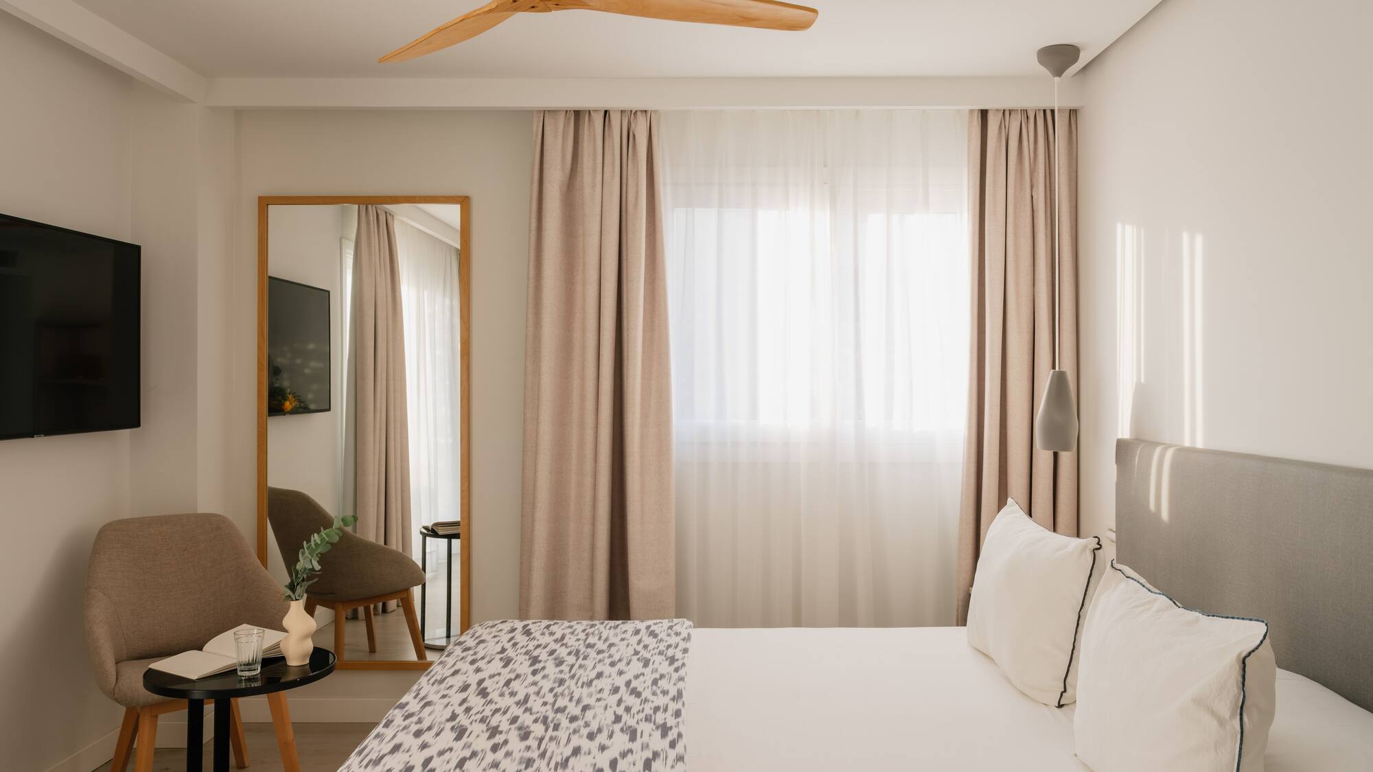 a room with a bed and a fan