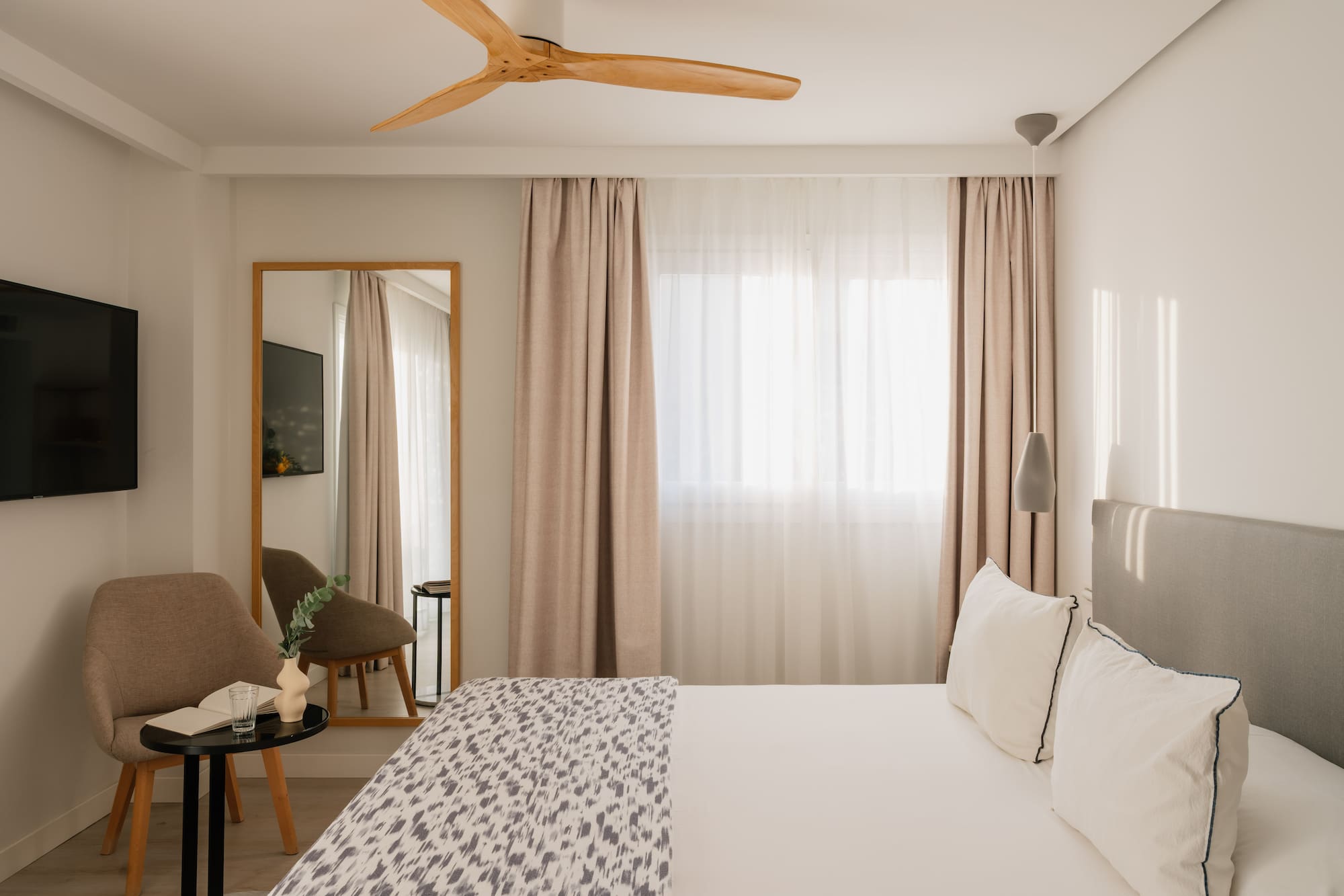 a room with a bed and a fan