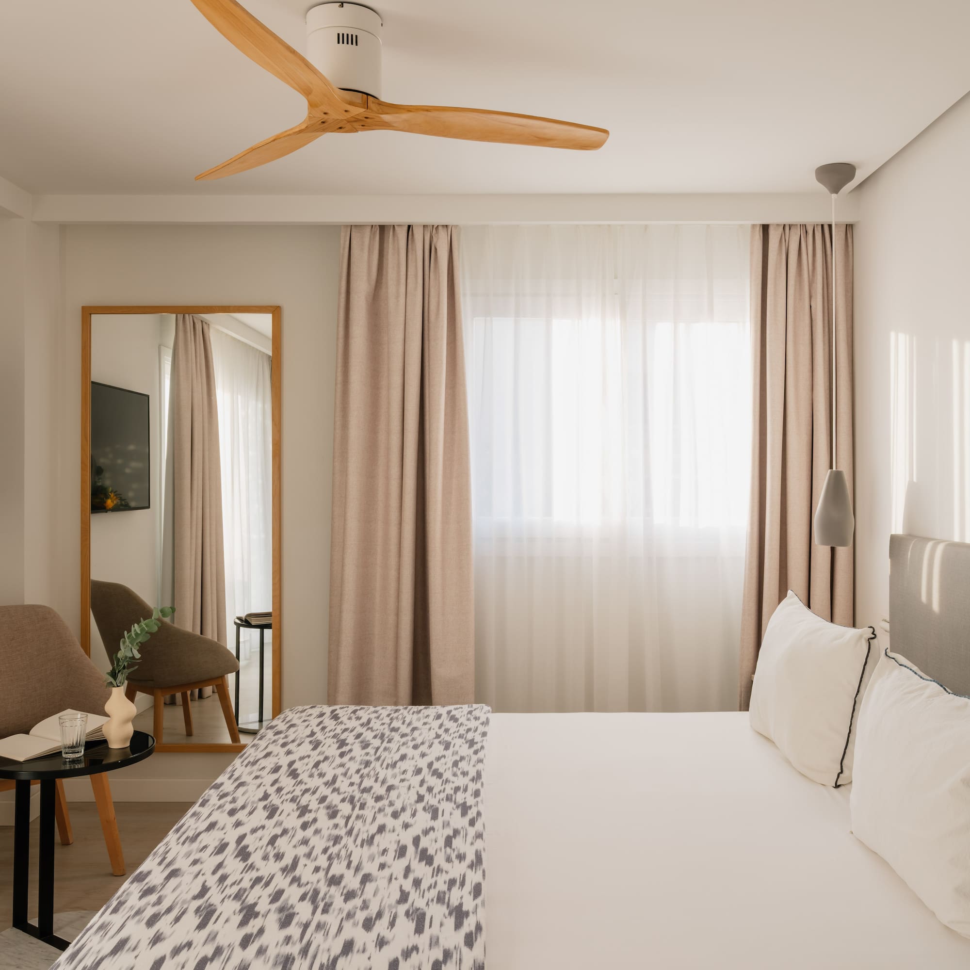 a room with a bed and a fan